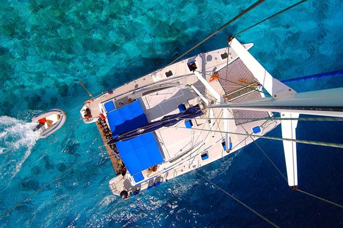 A multihull cruising through crystal clear waters