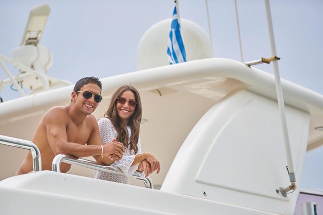 Happy couple enjoying their stay on a superyacht in Greece