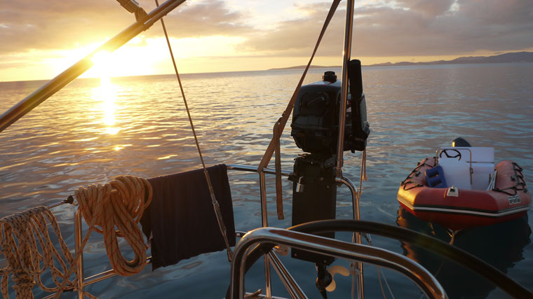 sunset view from the stern of a sailboat sunset view from the stern of a sailboat